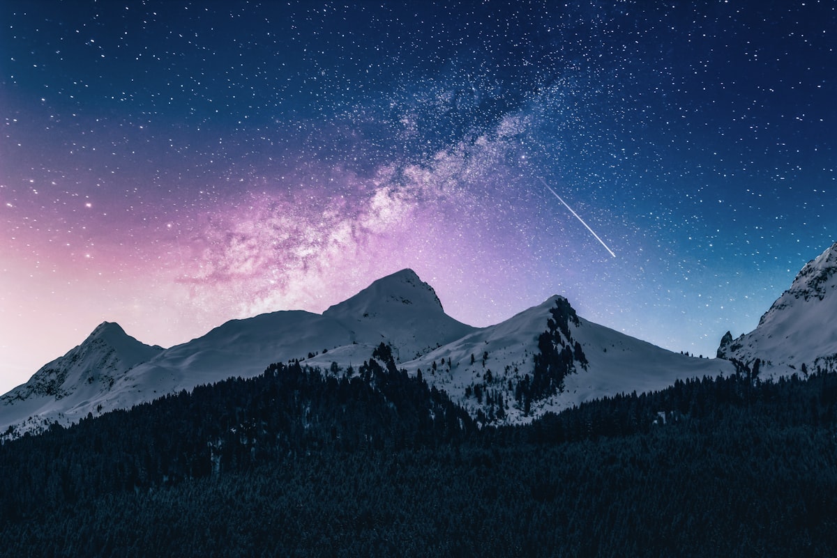 Milky Way over a mountain range — infinite points of light mapping an unseen geometry